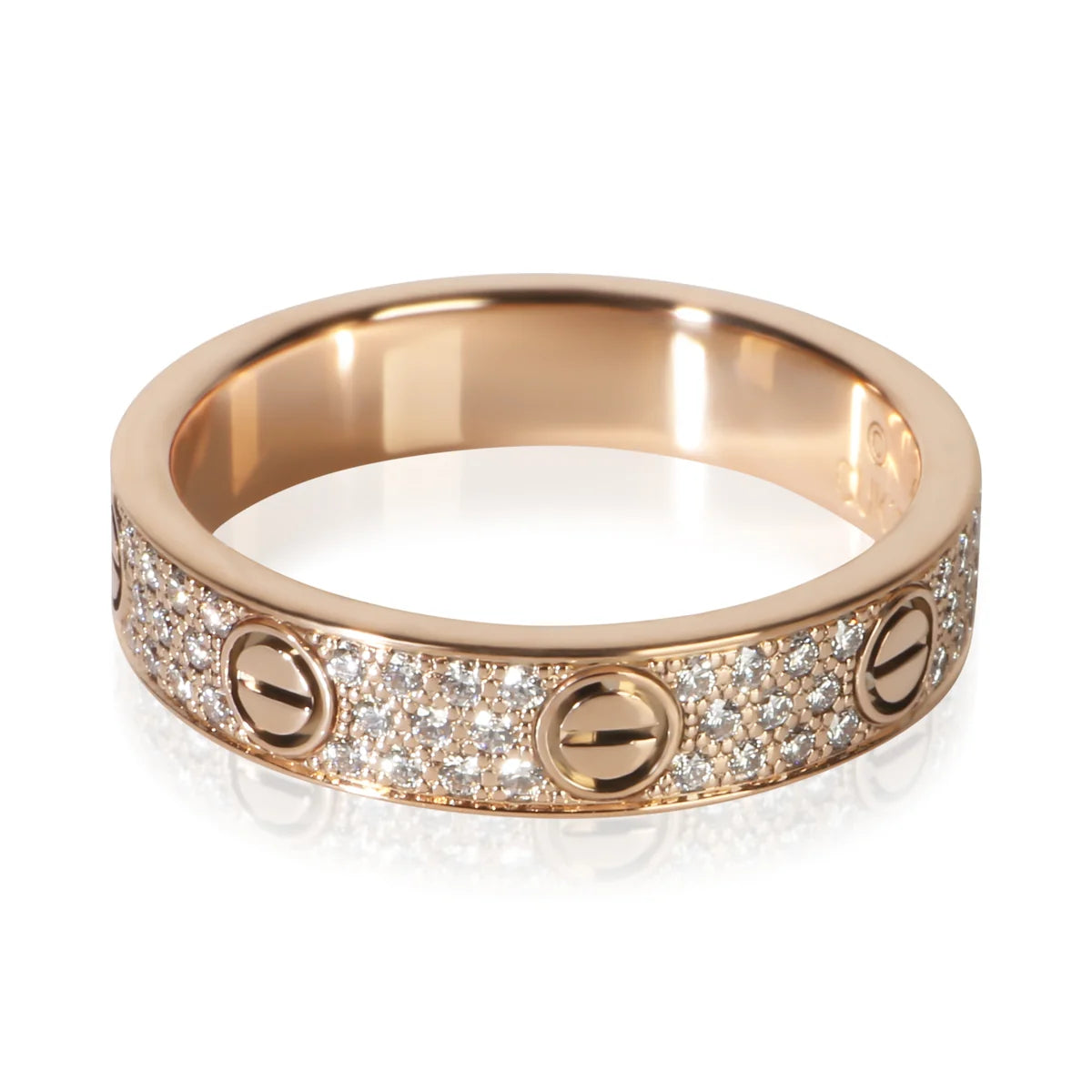 A rose gold ring featuring a pavé diamond band with three screw-head motifs, photographed on a clean white background with a soft reflection.